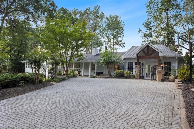263 Mountainview Cir, Canton, GA 30115 - view of front of home with a chimney, stone siding, covered porch, and a standing seam roof