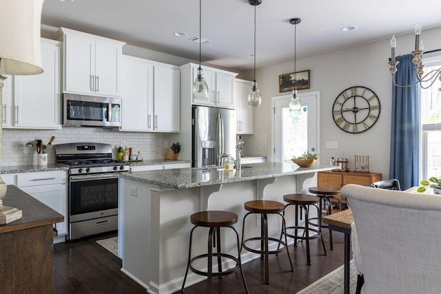 2099 Lakeview Bend Way, Buford, GA 30519 - kitchen featuring stainless steel appliances, dark wood-style flooring, backsplash, white cabinetry, and recessed lighting