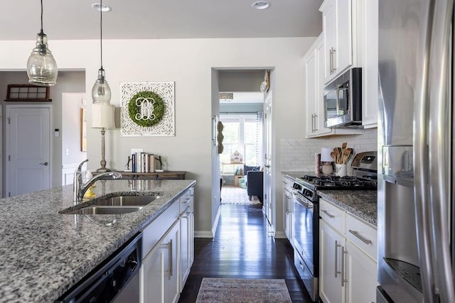 2099 Lakeview Bend Way, Buford, GA 30519 - kitchen with appliances with stainless steel finishes, white cabinetry, dark wood-style flooring, decorative backsplash, and light stone counters
