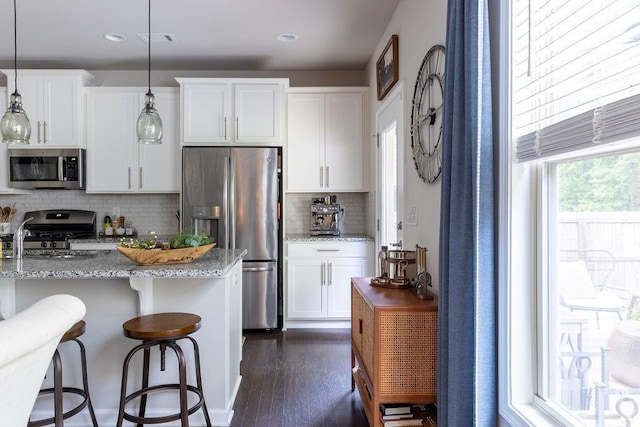 2099 Lakeview Bend Way, Buford, GA 30519 - kitchen with stainless steel appliances, decorative backsplash, white cabinetry, light stone counters, and recessed lighting