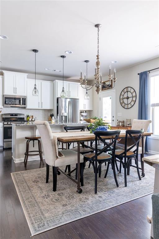 2099 Lakeview Bend Way, Buford, GA 30519 - dining room featuring dark wood-style floors, recessed lighting, and a chandelier