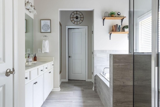 2099 Lakeview Bend Way, Buford, GA 30519 - full bathroom featuring vanity, a garden tub, and wood finished floors