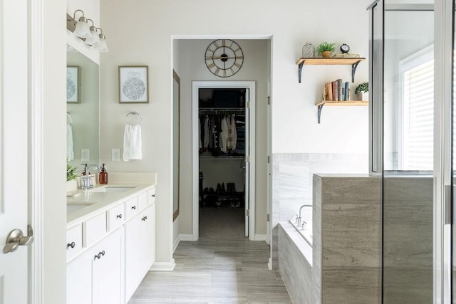 2099 Lakeview Bend Way, Buford, GA 30519 - bathroom featuring double vanity, a garden tub, and a spacious closet
