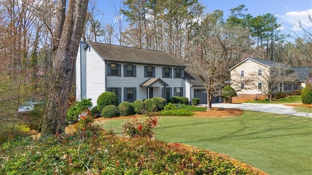view of front of property with a garage, concrete driveway, and a front lawn