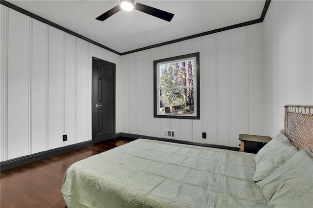 bedroom featuring crown molding, ceiling fan, and dark hardwood / wood-style floors