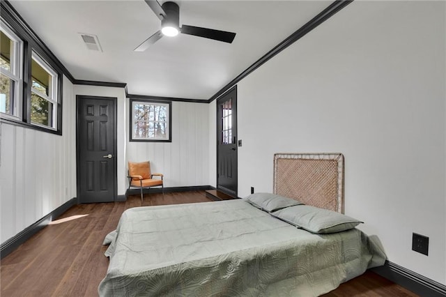 bedroom with ornamental molding, ceiling fan, and dark hardwood / wood-style flooring