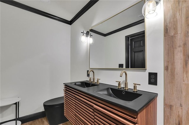 bathroom featuring vanity, hardwood / wood-style floors, and crown molding