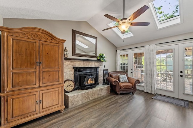 sitting room featuring lofted ceiling with skylight, french doors, ceiling fan, and wood finished floors