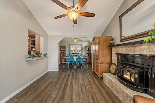 living room featuring baseboards, dark wood-style flooring, lofted ceiling, and ceiling fan