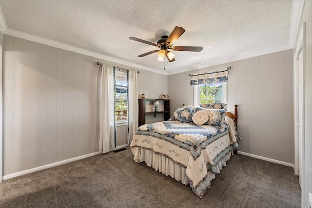 bedroom with crown molding, dark colored carpet, and multiple windows
