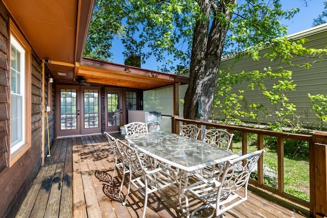 deck with outdoor dining area and french doors