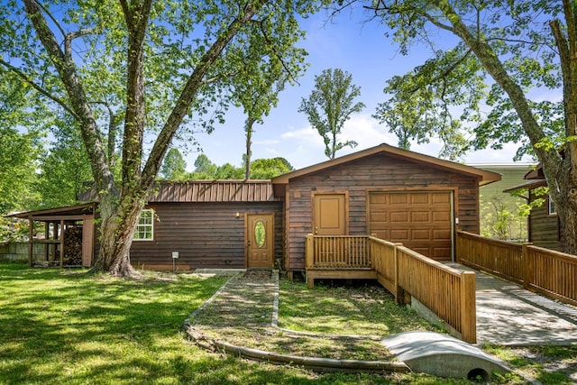 view of front of home featuring a garage and a front lawn