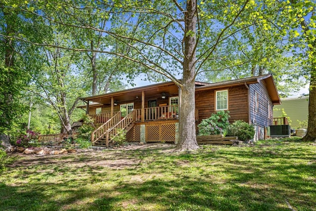 view of front of property featuring covered porch, a ceiling fan, central air condition unit, a front yard, and stairs