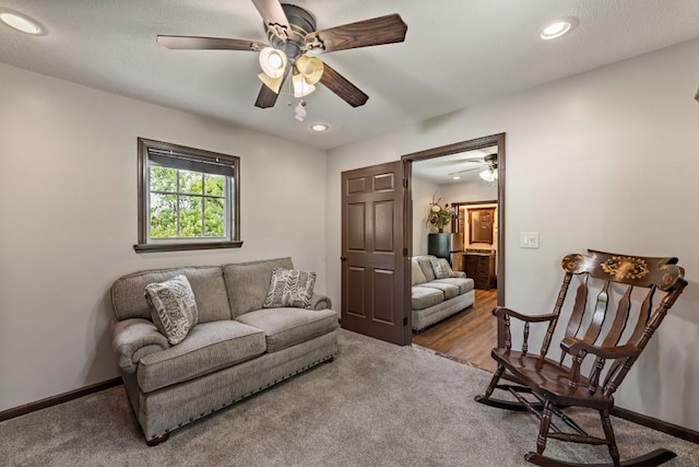 carpeted living room with baseboards, recessed lighting, and ceiling fan