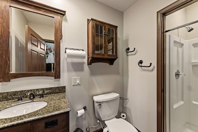 full bathroom featuring walk in shower, toilet, and vanity