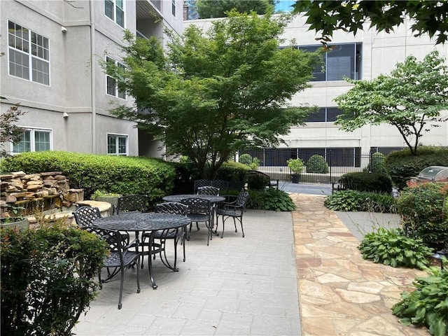1075 Peachtree Walk Unit A205, Atlanta, GA 30309 - surrounding community featuring outdoor dining space and a patio area