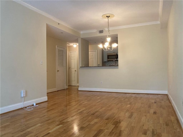 1075 Peachtree Walk Unit A205, Atlanta, GA 30309 - spare room with a chandelier, wood finished floors, and crown molding