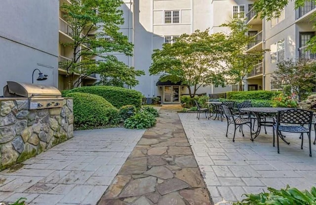 1075 Peachtree Walk Unit A205, Atlanta, GA 30309 - view of patio featuring outdoor dining space