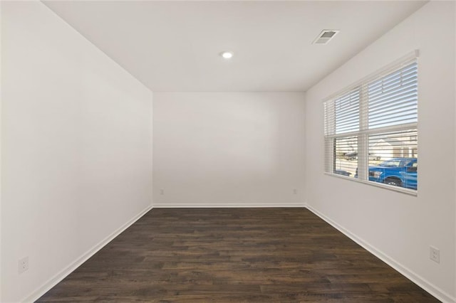 spare room with baseboards, dark wood-style floors, and recessed lighting