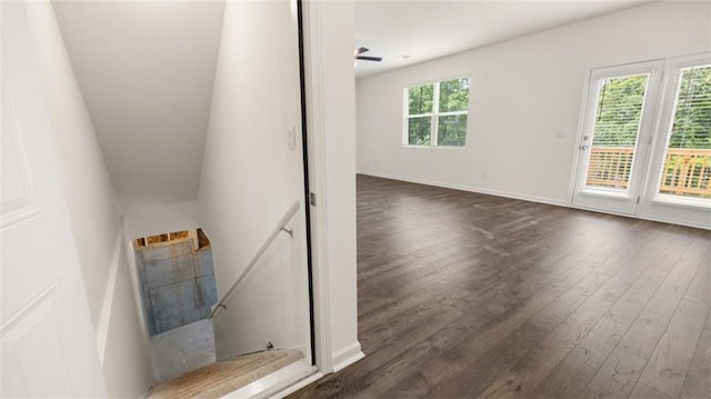 stairway with hardwood / wood-style flooring and baseboards
