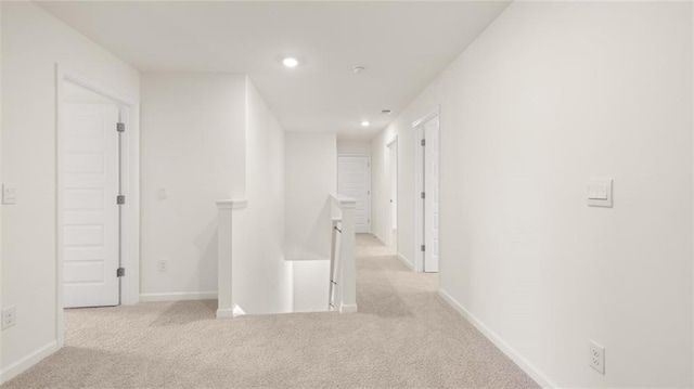 corridor featuring an upstairs landing, carpet floors, recessed lighting, and baseboards