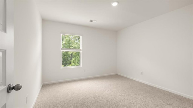 unfurnished room with carpet and baseboards
