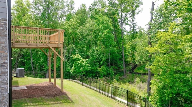 view of yard with a deck and central AC