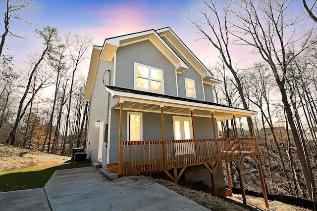 view of front of property with cooling unit and a porch