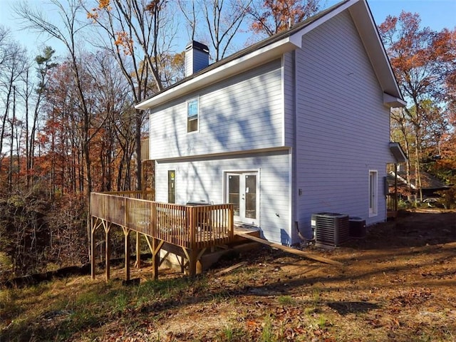 rear view of property with french doors, a deck, and central air condition unit