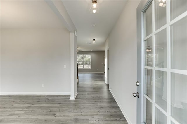 hall featuring baseboards and wood finished floors