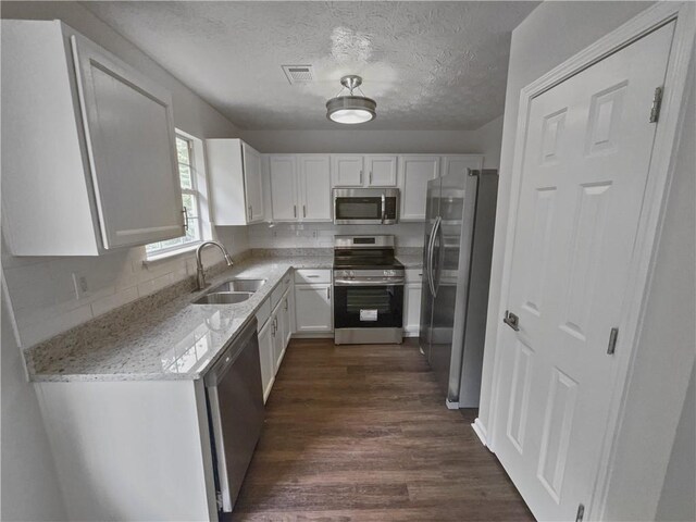 kitchen featuring white cabinetry, sink, stainless steel appliances, and dark hardwood / wood-style flooring