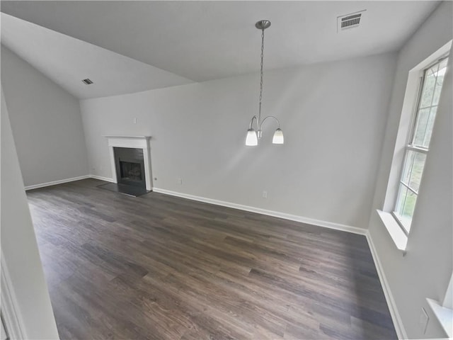 unfurnished living room featuring a notable chandelier, dark hardwood / wood-style flooring, and lofted ceiling