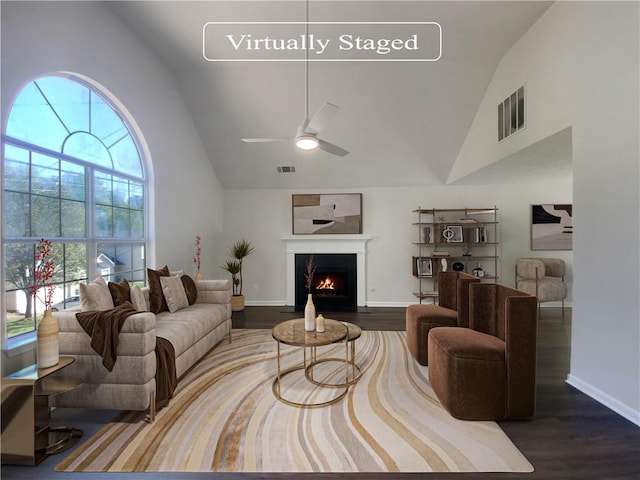 living room featuring high vaulted ceiling, ceiling fan, and wood-type flooring