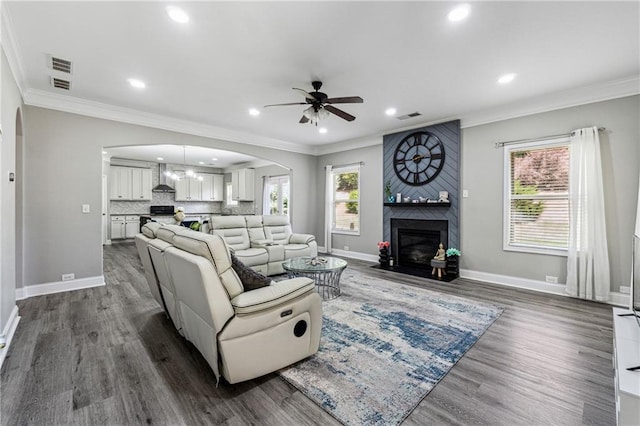 4850 Wilshire Xing, Cumming, GA 30040 - living area featuring arched walkways, ornamental molding, a ceiling fan, wood finished floors, and recessed lighting