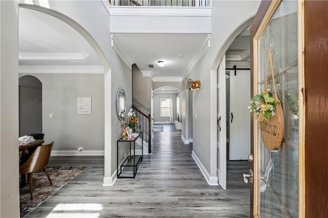 4850 Wilshire Xing, Cumming, GA 30040 - foyer with wood finished floors, ornamental molding, stairway, baseboards, and arched walkways