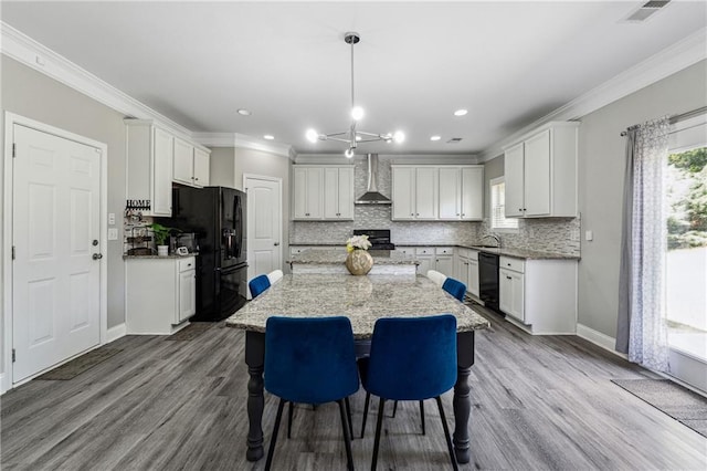 4850 Wilshire Xing, Cumming, GA 30040 - kitchen featuring black appliances, wall chimney range hood, ornamental molding, decorative backsplash, and a center island