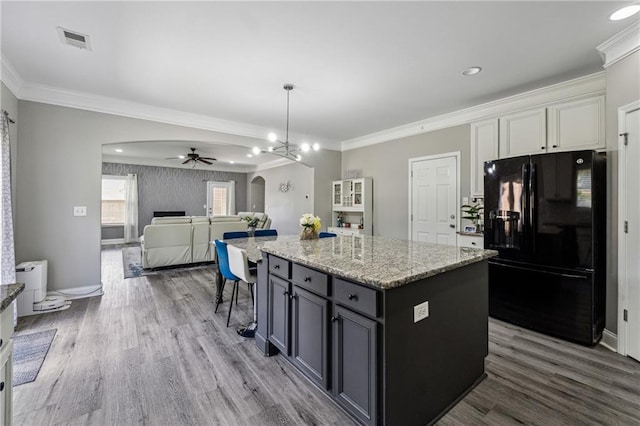 4850 Wilshire Xing, Cumming, GA 30040 - kitchen featuring freestanding refrigerator, arched walkways, a ceiling fan, wood finished floors, and crown molding