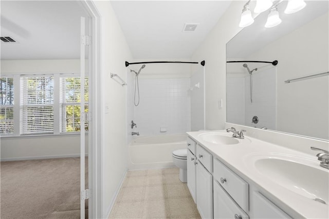 full bath featuring a sink, visible vents, toilet, and double vanity