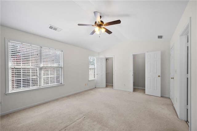 unfurnished bedroom featuring vaulted ceiling, carpet flooring, baseboards, and visible vents