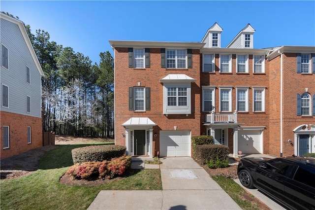 townhome / multi-family property with an attached garage, brick siding, and driveway