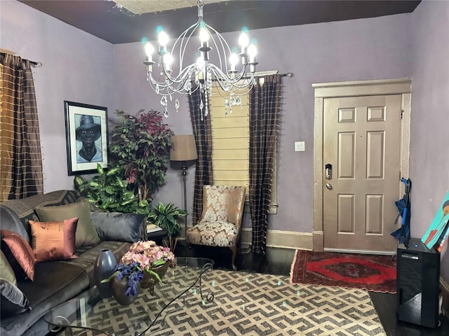 living room with baseboards, an inviting chandelier, and wood finished floors