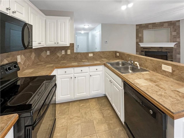 532 Terrapin Ln, Winder, GA 30680 - kitchen featuring black appliances, a peninsula, a sink, and white cabinets