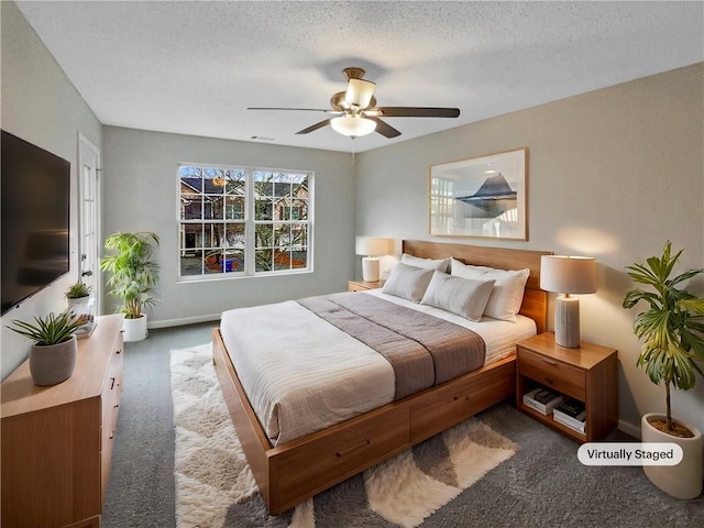 532 Terrapin Ln, Winder, GA 30680 - bedroom with a textured ceiling, dark carpet, a ceiling fan, and baseboards