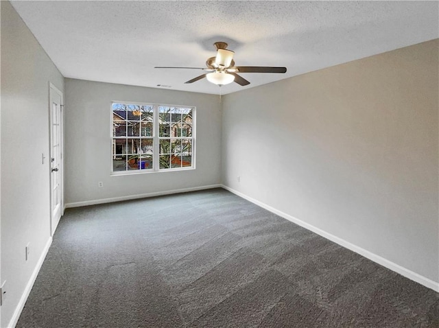 532 Terrapin Ln, Winder, GA 30680 - spare room featuring a textured ceiling, dark carpet, a ceiling fan, and baseboards