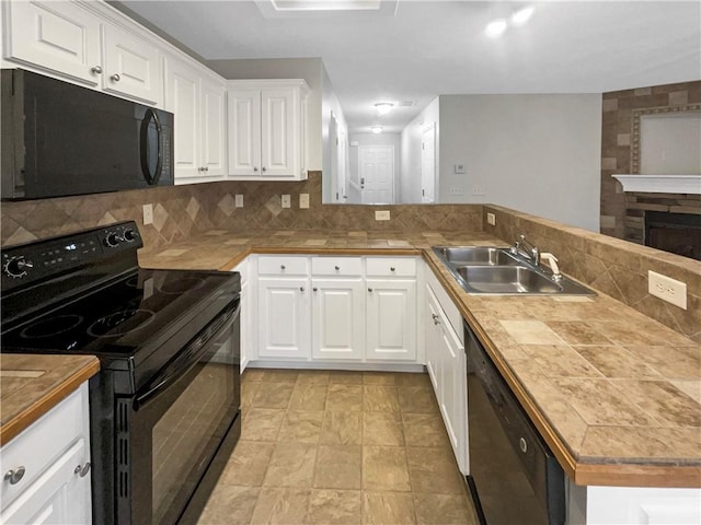 532 Terrapin Ln, Winder, GA 30680 - kitchen with white cabinetry, a sink, a peninsula, and black appliances