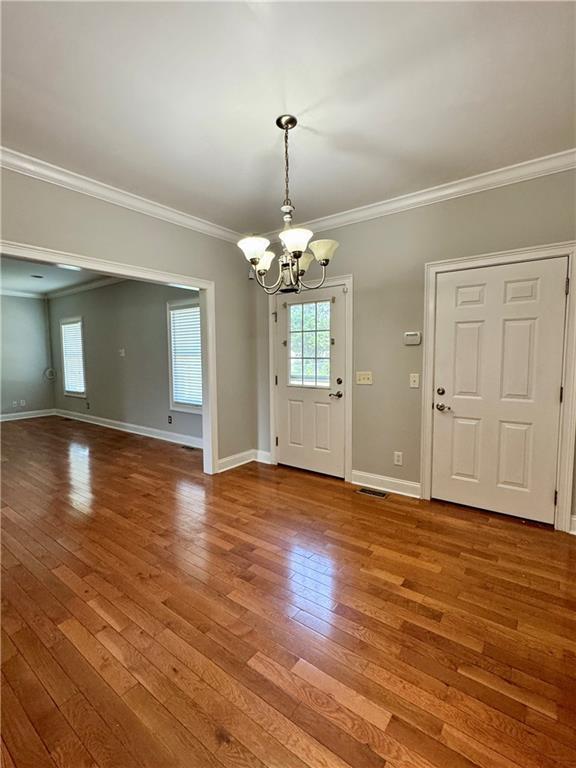 167 Techview Dr SW, Calhoun, GA 30701 - entrance foyer featuring a chandelier, crown molding, hardwood / wood-style flooring, plenty of natural light, and baseboards