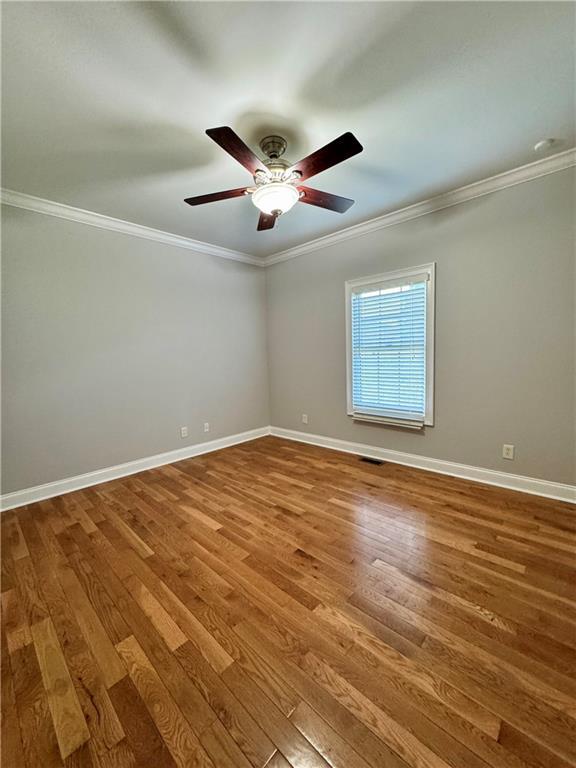 167 Techview Dr SW, Calhoun, GA 30701 - empty room featuring crown molding, wood finished floors, baseboards, and a ceiling fan