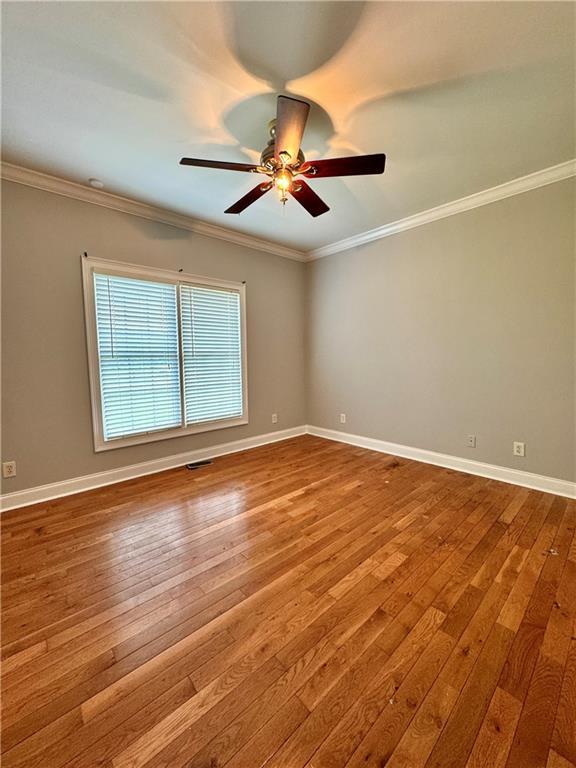167 Techview Dr SW, Calhoun, GA 30701 - empty room featuring hardwood / wood-style flooring, a ceiling fan, crown molding, and baseboards