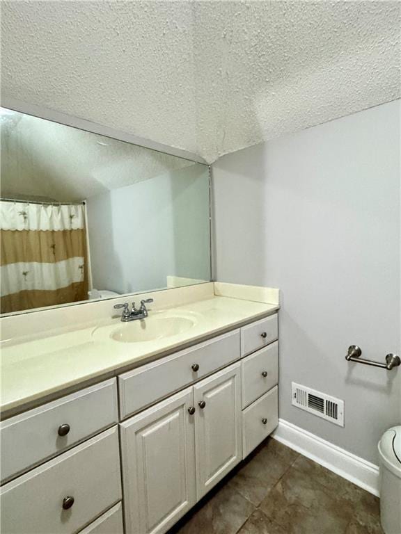167 Techview Dr SW, Calhoun, GA 30701 - full bathroom featuring a textured ceiling, baseboards, vanity, toilet, and tile patterned floors
