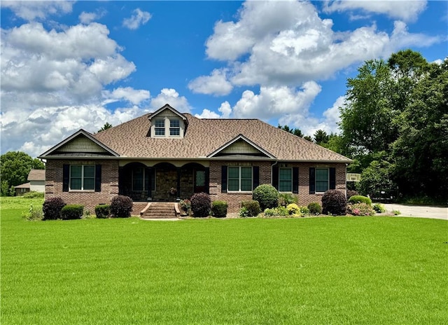 167 Techview Dr SW, Calhoun, GA 30701 - view of front of home with a porch, a front yard, brick siding, and a shingled roof